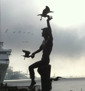 Statue of a boy feeding birds on Pier 22 Galveston, Tx